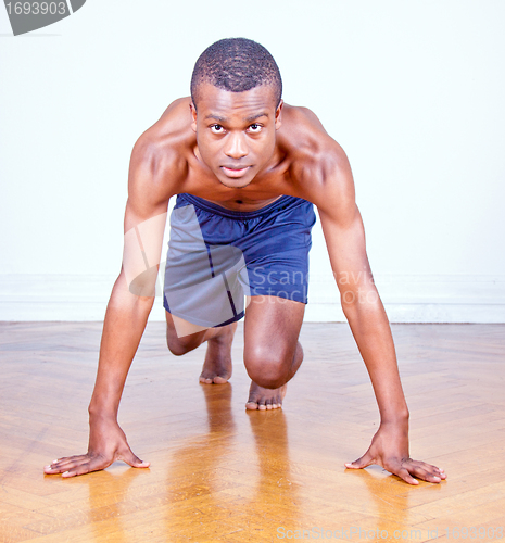 Image of young muscular boy is doing a workout