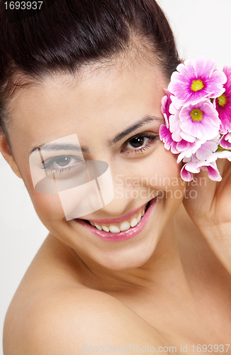 Image of young beautiful brunette woman with flower