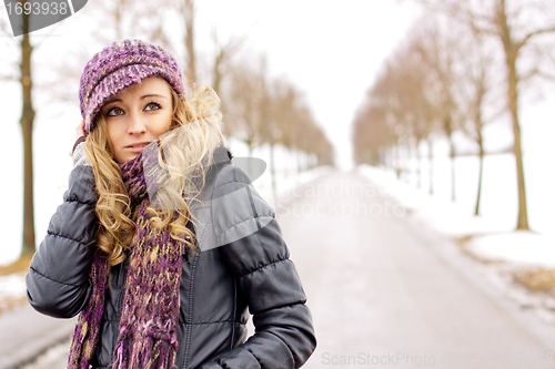 Image of young woman outside in winter in snow cold