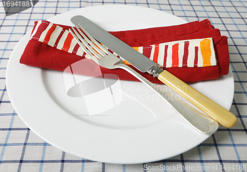Image of Knife, fork, table and napkin