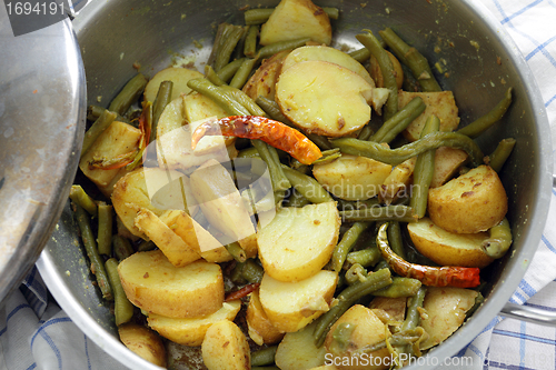 Image of Cooking potato and bean curry