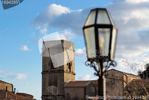 Image of Medieval church and street lantern at sunset