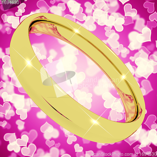Image of Gold Ring On Pink Heart Bokeh Background Representing Love Valen