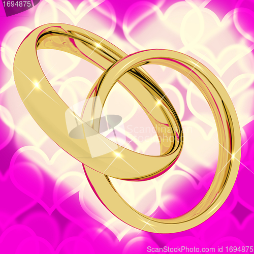 Image of Gold Rings On Pink Heart Bokeh Background Representing Love Vale