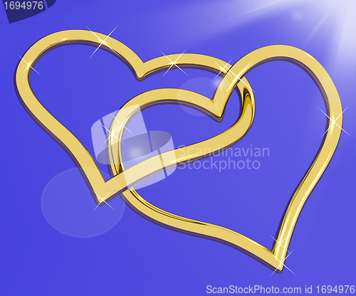 Image of Gold Heart Shaped Rings On Blue Representing Love And Romance