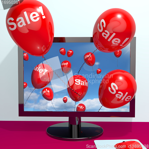 Image of Sale Balloons Coming From Computer Showing Internet Promotion Di