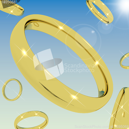 Image of Gold Rings Falling From the Sky Representing Love Engagement Or 