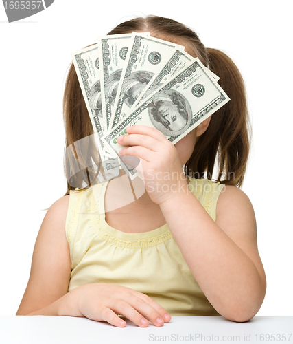Image of Cute little girl with dollars