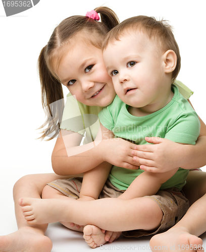Image of Two children (a girl and a boy) are having fun