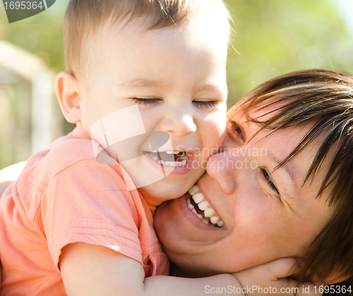 Image of Portrait of a mother hugging her son