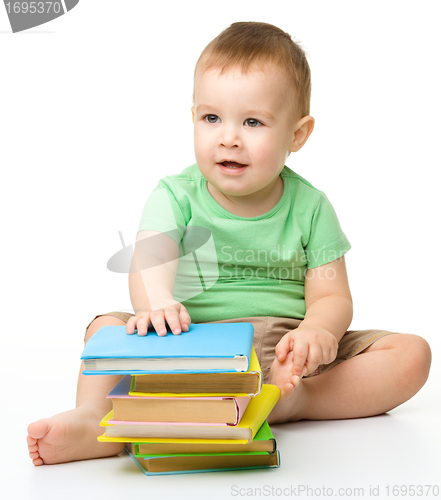 Image of Portrait of a cute little boy with books