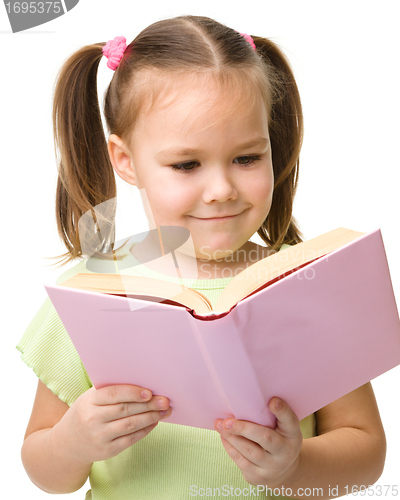 Image of Cute little girl reads a book