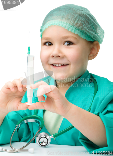 Image of Cute little girl is playing doctor with syringe