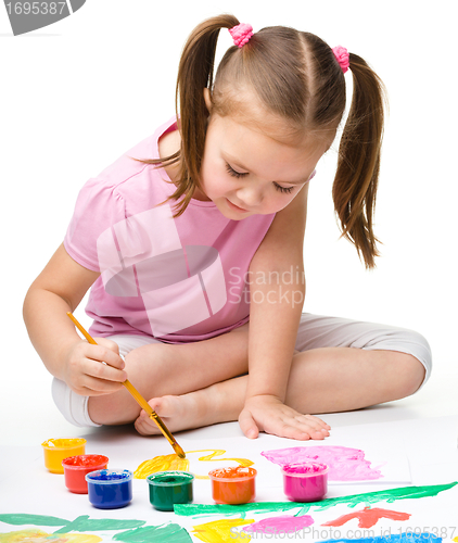 Image of Cute cheerful child play with paints