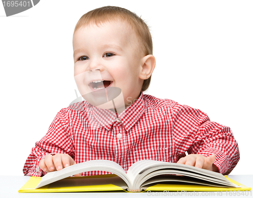 Image of Little child play with book