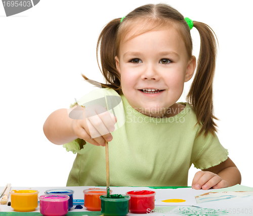 Image of Cute cheerful child play with paints