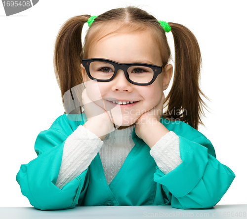 Image of Little girl is playing doctor