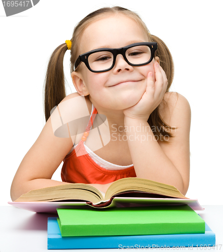 Image of Cute little girl is reading book