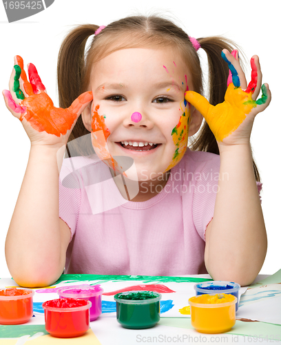 Image of Portrait of a cute girl with painted hands