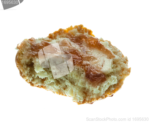 Image of Half scone with butter and jam isolated