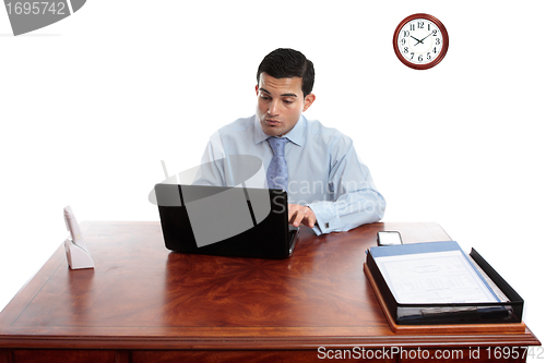 Image of Businessman iworking at office desk