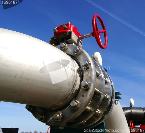 Image of Industrial zone, Steel pipelines and valves against blue sky