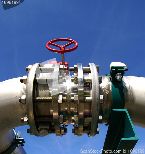 Image of Industrial zone, Steel pipelines and valves against blue sky