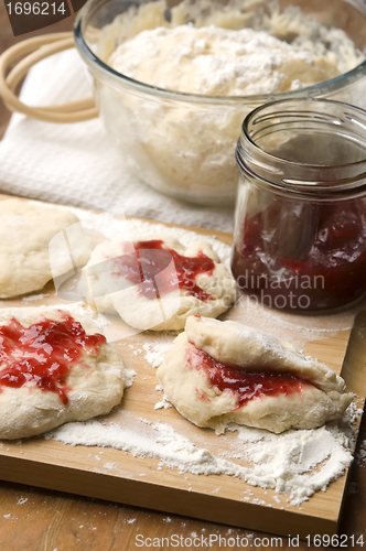 Image of Dough with marmelade on wooden board