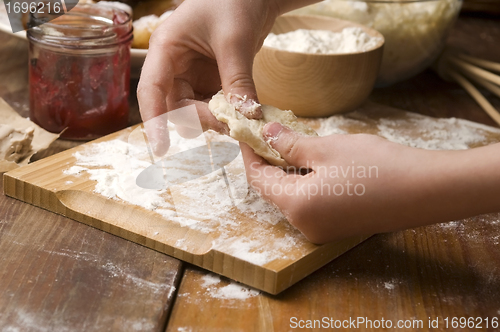 Image of Detail of hands kneading dough