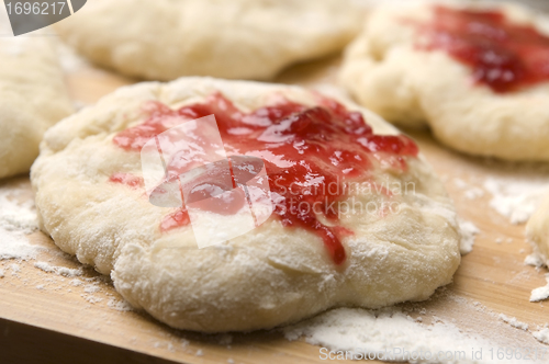 Image of Dough with marmelade on wooden board