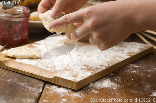 Image of Detail of hands kneading dough