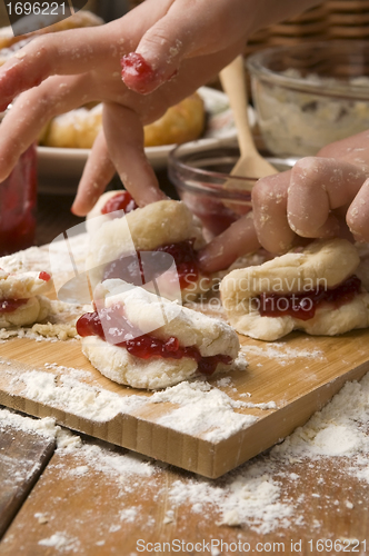 Image of Detail of hands kneading dough