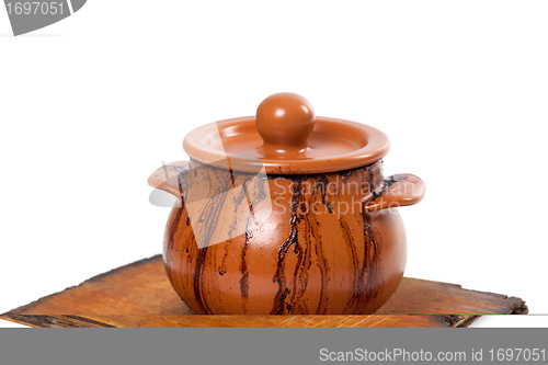 Image of Dirty ceramic pot on old kitchen board