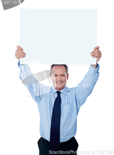 Image of Businessman holding a blank billboard over the head