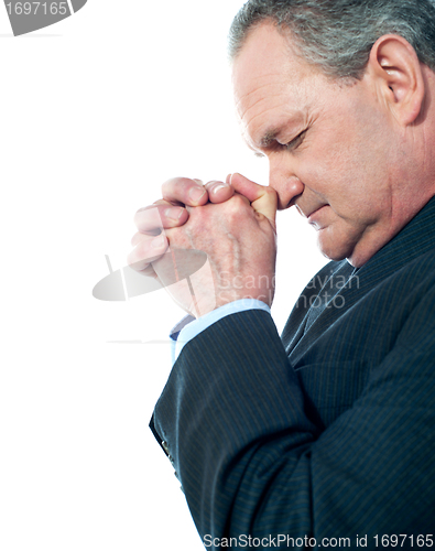 Image of Portrait of matured businessman praying