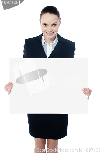 Image of Female executive showing blank billboard to camera