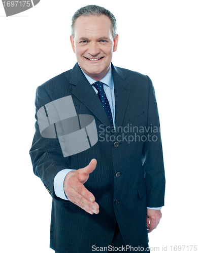 Image of Confident modern businessman offering handshake