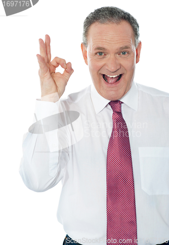 Image of Happy satisfied businessman with okay hand sign