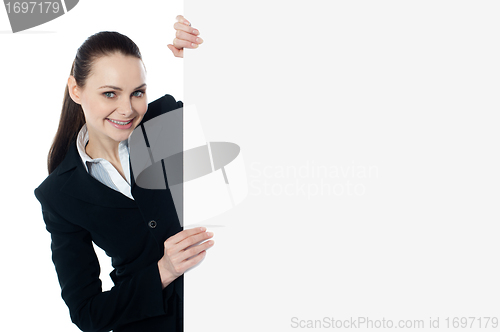 Image of Female executive holding blank whiteboard