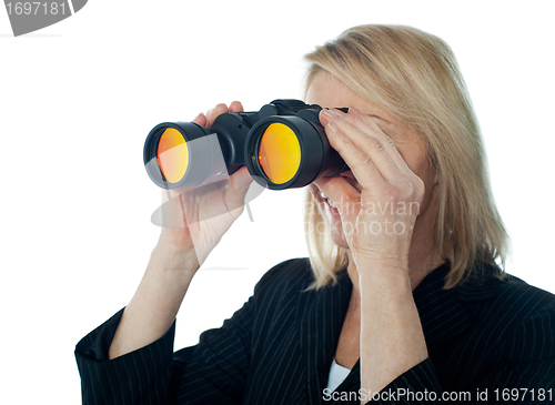 Image of Female executive monitoring through binocular