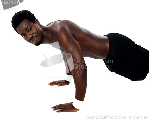 Image of Handsome fit shirtless man doing pushups