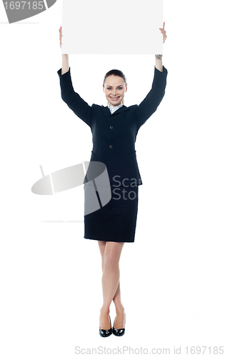 Image of Young businesswoman holding a blank signboard