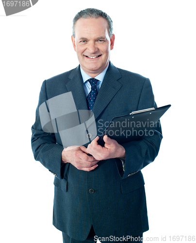 Image of Smiling elderly businessman holding clipboard