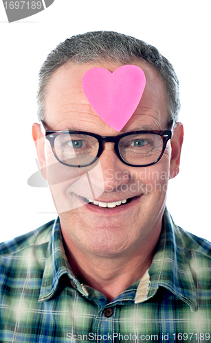 Image of Handsome senior man with paper heart on his forehead