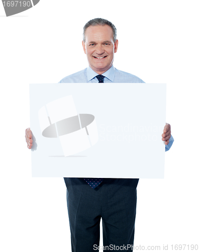 Image of Handsome man holding blank white billboard