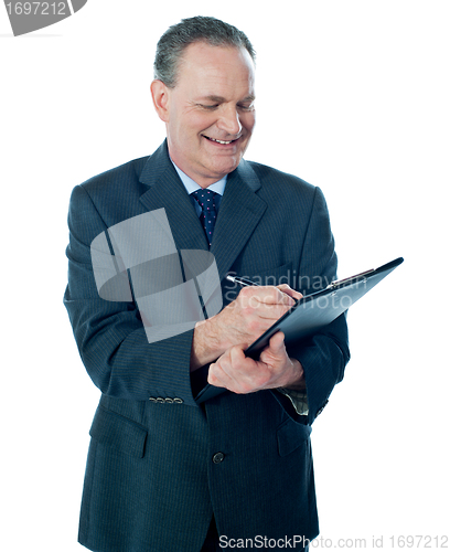 Image of Elder confident man making business notes