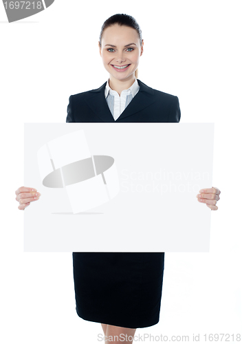 Image of Businesswoman holding a blank white poster