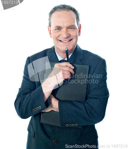 Image of Welldressed corporate person holding document