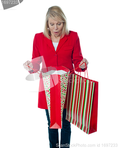 Image of Lady surprised to see empty shopping bag