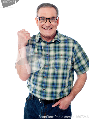 Image of Excited elderly male dressed in casuals